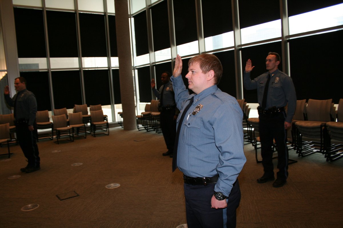 kcpolice's tweet photo. A socially distant swearing-in for our four new lateral-transfer officers today (meaning they were already police officers at other agencies). We need them now more than ever and welcome them to KCPD. https://t.co/icvB0f1LTK