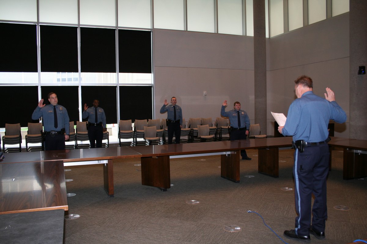 kcpolice's tweet photo. A socially distant swearing-in for our four new lateral-transfer officers today (meaning they were already police officers at other agencies). We need them now more than ever and welcome them to KCPD. https://t.co/icvB0f1LTK