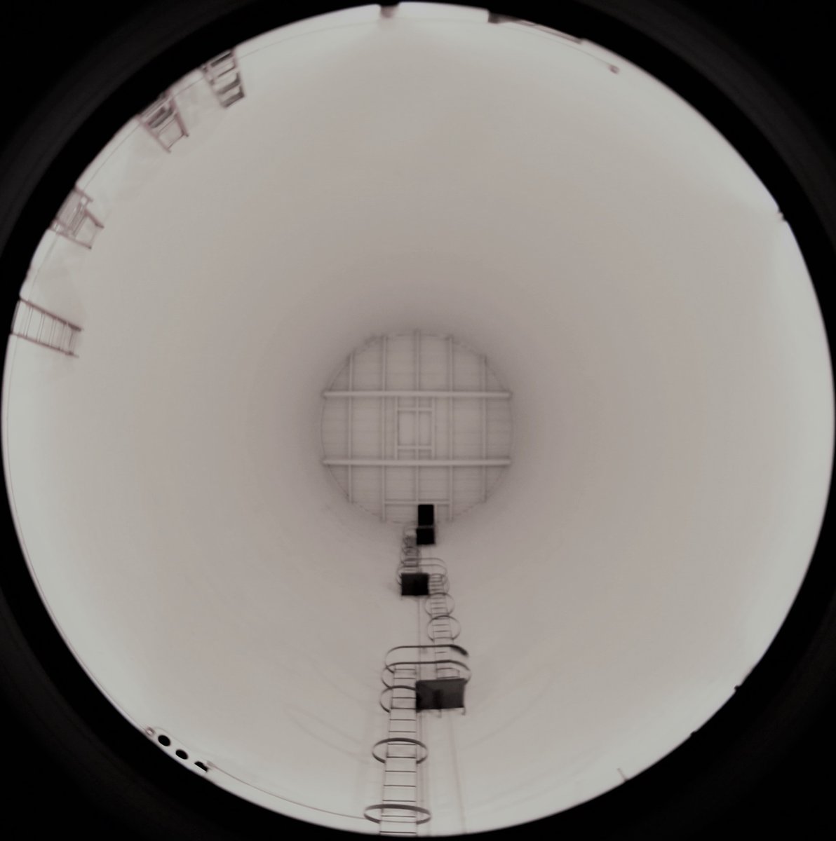 Looking directly up inside the seven-storey tall concrete cylinder ('the pier') on which the 4m telescope sits, with a 180 degree lens at the centre of the floor