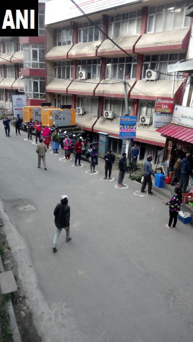 ANI's tweet photo. Shimla: People outside a shop stand at a distance from each other as they practice social distancing. #Coronavirus https://t.co/Ej0Hg2jRFu