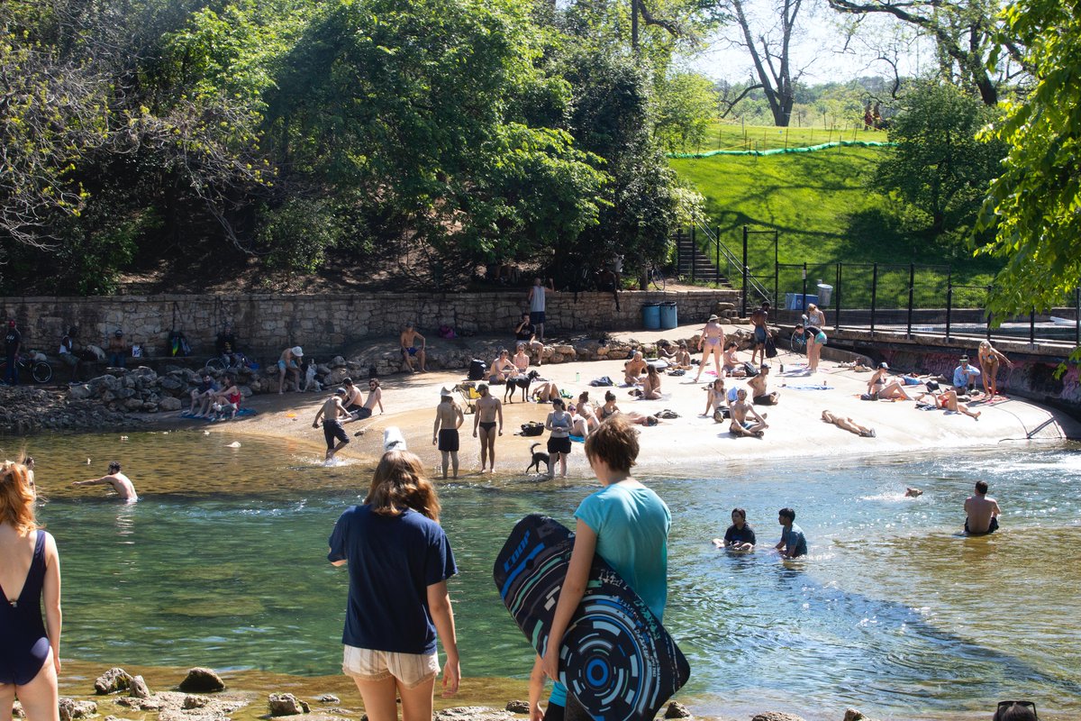 People congregating at the Barton Springs spillway yesterday in defiance of...