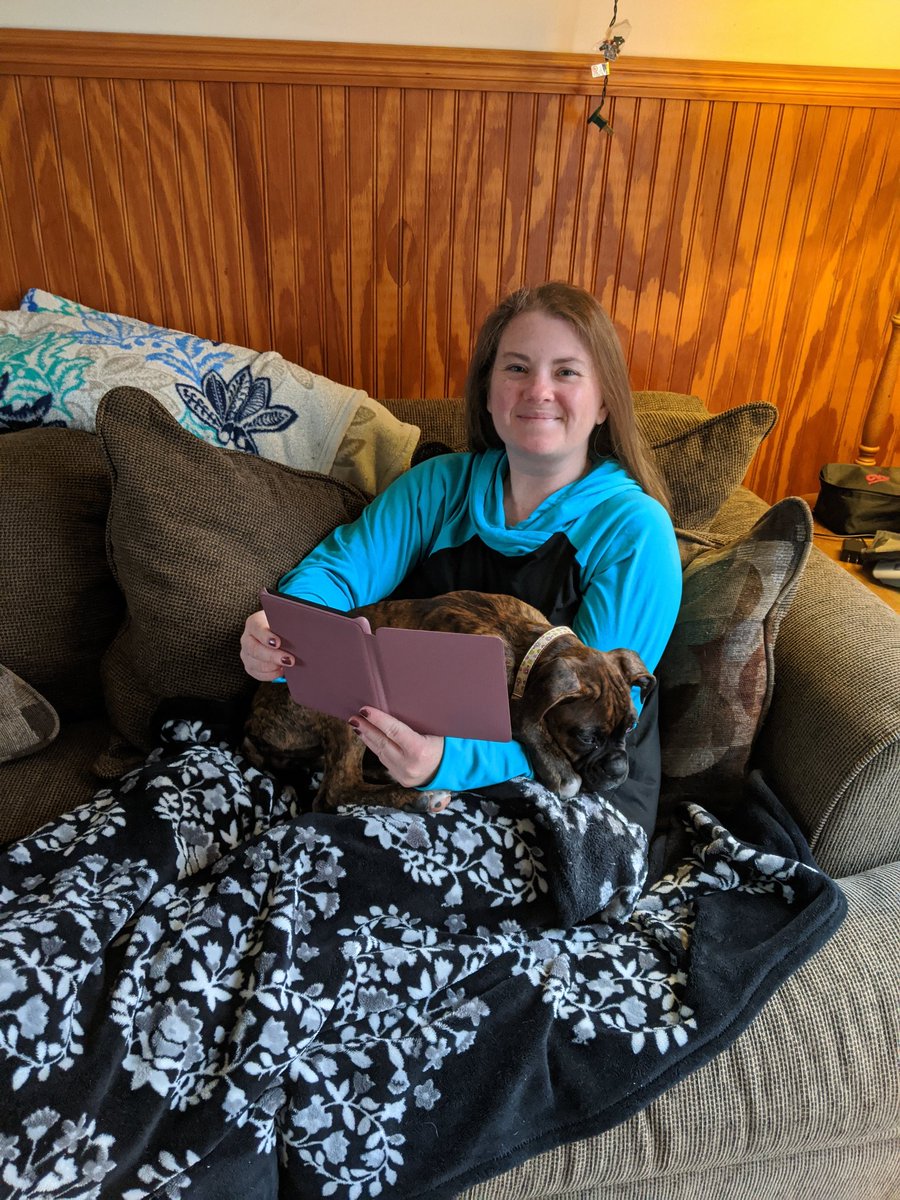 Ms. Blaesi enjoying a good book on her Kindle. Her puppy, Mia didn't seem to thrilled with the choice of book- she fell asleep! #gccares #GCPride