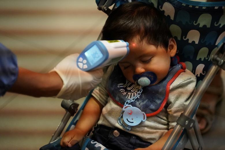 escondidos's tweet photo. Francisco, 1, from Chile, sleeps inside his stroller while a health ministry official measures his body temperature inside El Dorado International Airport after flights were suspended to curb the spread of coronavirus in Bogota, Colombia.

#COVID19 https://t.co/ENcqPFcdqD
