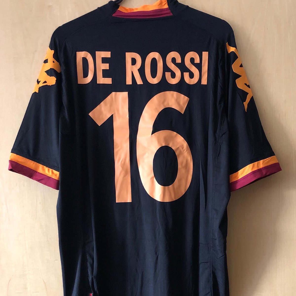 . @ASRomaENThird Kit, 2012/13 @Kappa_UKPersonalised: De Rossi, 16Damn extra-tight Kappa shirts. But I’m a sucker for Roma’s blue or black shirtsI got this one the day after De Rossi announced his departure from Roma, one of my favourite players ever  #FootballShirtCollection
