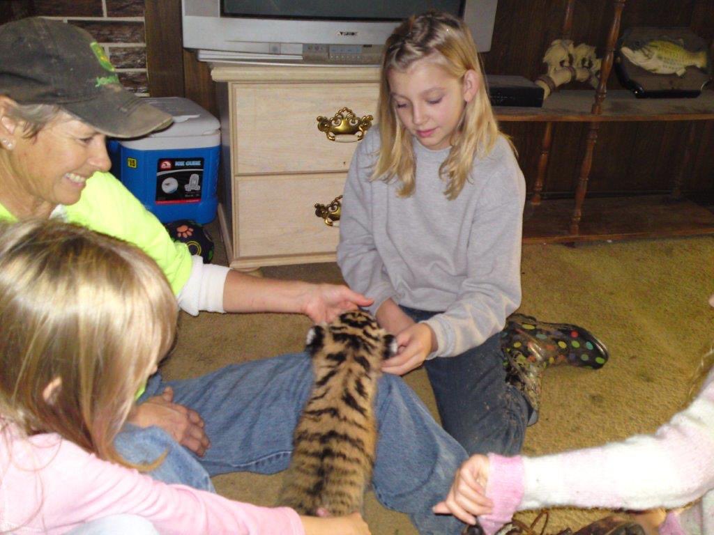shelbssm_'s tweet photo. You know you’re from Oklahoma when.. Here’s me in Joe Exotic’s living room circa 2010 playing with a baby tiger. #TigerKing #Netflix https://t.co/4pc4rGcR78