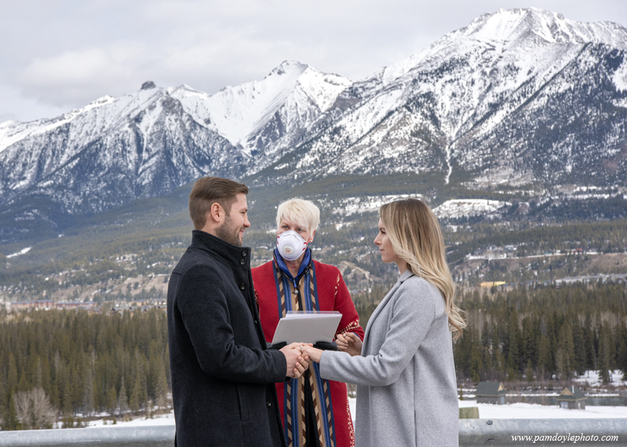 pphotodog's tweet photo. Love in the Age of #COVID19 AB marriage commissioner Twyla Jacobson performs a wedding ceremony wearing an N95 mask and gloves in #canmore on March 27, 2020. https://t.co/adWuQwoN9L https://t.co/Z2FHFxh4Qx