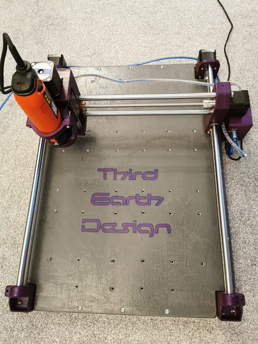 ted_thirdearth's tweet photo. This is my build of Nikodem's DIY Dremel CNC. It has a 600x440mm footprint, printed in ABS (mostly stock design apart from a few minor changes), a plywood baseboard coated in a layer of resin to make it hard-wearing and of course, some Third Earth Design customization! https://t.co/D2OzyrRxZJ