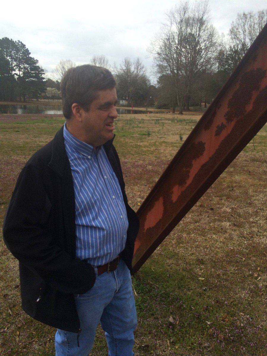 5/10 - Zack Rogers is standing next to a 28-foot long steel beam that landed in his parents' front yard in Bennettsville.