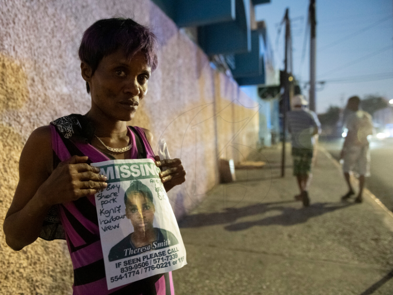JamaicaGleaner's tweet photo. PHOTO: Marrisa Reid holds a poster showing her 15-years-old daughter Theresa Smith who has been missing since Monday March 23, 2020. Reid along with friends and family were seen walking along  on Slipe Pen Road showing the poster to passersby. (@taylor2nd) #GLNRRoving https://t.co/Z1cI6hEHnt