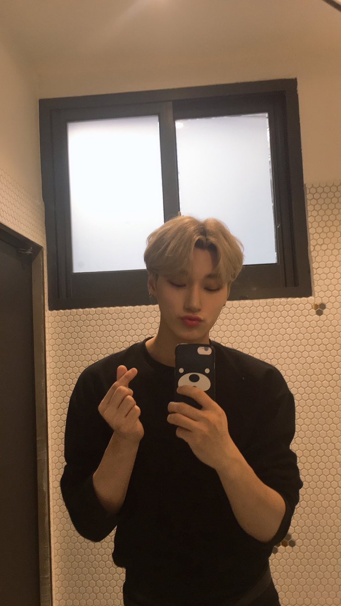 san and seokmin taking a mirror selfie in the same place