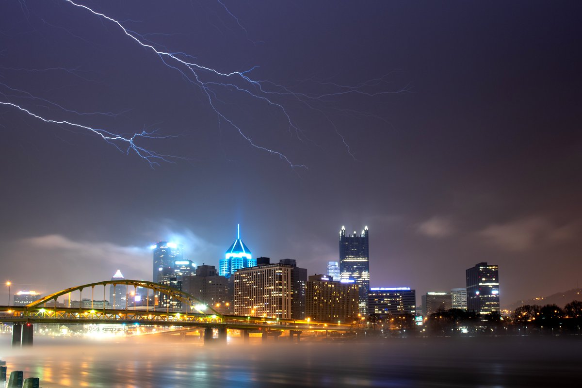 DaveDiCello's tweet photo. More lightning from last night's storms in #Pittsburgh. The reason I'm posting this one by itself and not with the 3 others in the thread is because it really stands out with the fog on the river. The lightning 'reaching' towards the city with glowing fog on the water was surreal https://t.co/GThrXypqlf