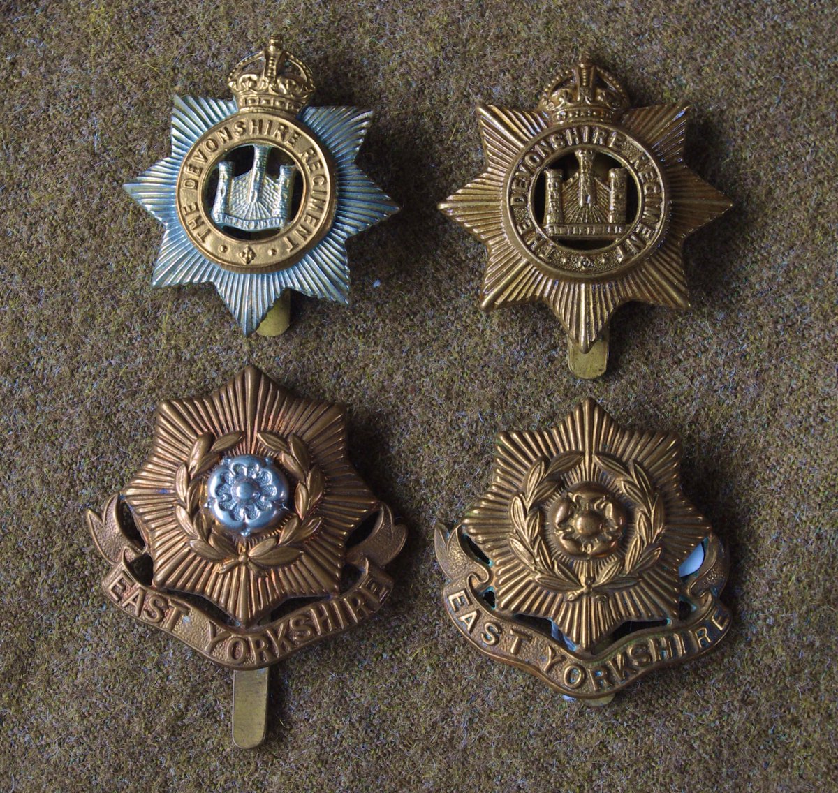 Cap Badges of the First World War: Some multi-part badges, where one metal was laid on another, were simplified to brass (‘gilding metal’). This wasn’t to save on nickel - it was to reduce manufacturing steps. Here, Devonshire & East Yorkshire regiments  #WW1  #FWW