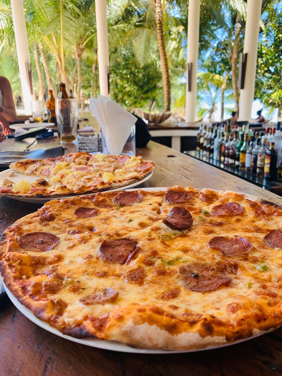 Lunch with a #pizza in hand and sand in your toes #paradise
