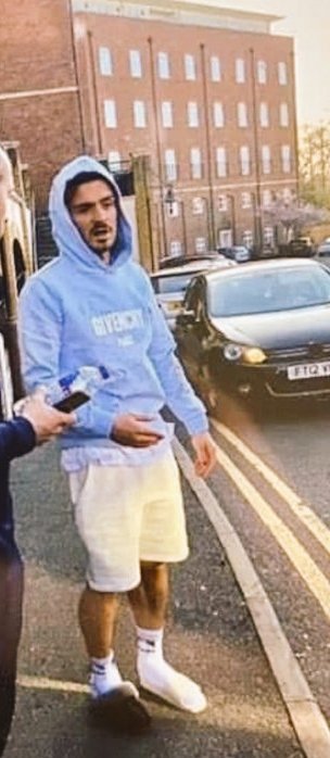 Jack Grealish has been spotted wearing one white slipper and one black slipper.

What on earth?