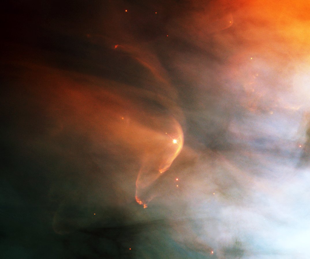 A bow shock around the young star LL Ori in Orion's Great Nebula, formed as the star's fast-moving solar wind encounters slow-moving material moving outward from the nebula's central region.Image: NASA/ESA and The Hubble Heritage Team (STScI/AURA)