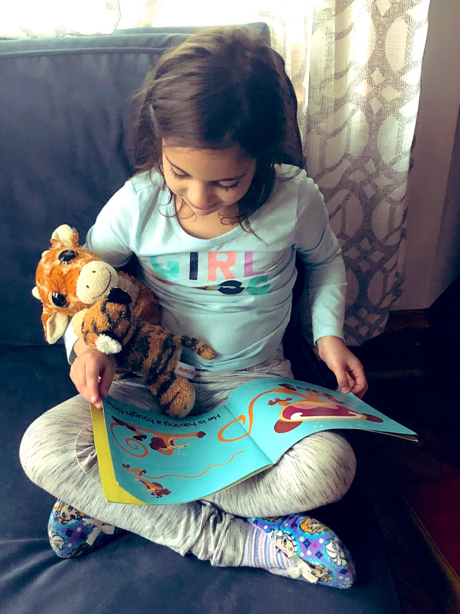 Kenza reading to Gigi and Rajah for Irving spirit week: read to a stuffie day. #irvingpride #springbreak2020