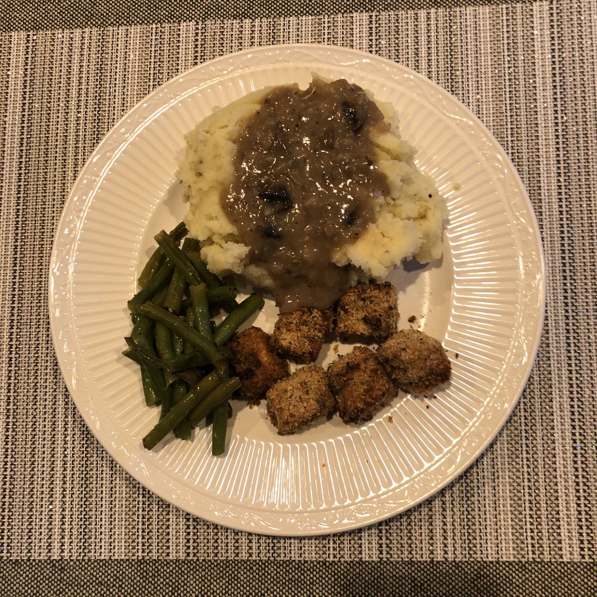 Baked breaded tofu, green beans, and mashed potatoes with mushroom gravy.