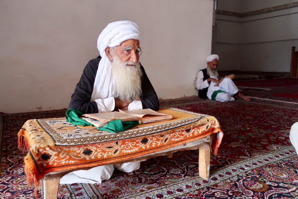 People of Herat: An old man reading the Quran at "Shahzada Abdul Qasim" mausoleum.Unknown artist.