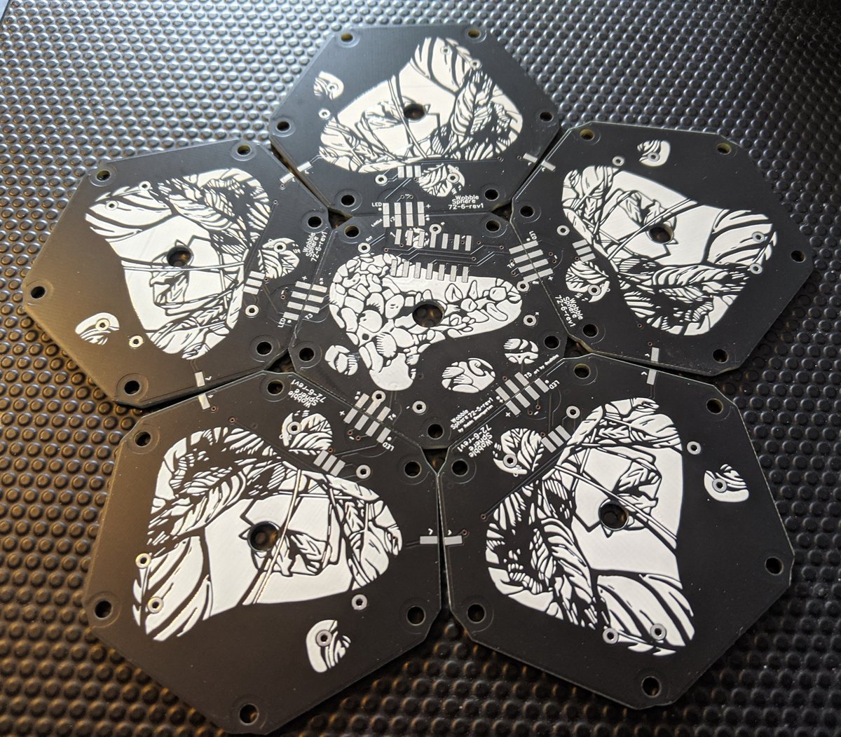 The PCBs I designed for the Wobble Sphere just arrived!! The back sides were just blank, so I decided to ask  @caiitlinz to create small abstract drawings for them. They came out so well! Once assembled these faces are hidden, like little art Easter eggs 