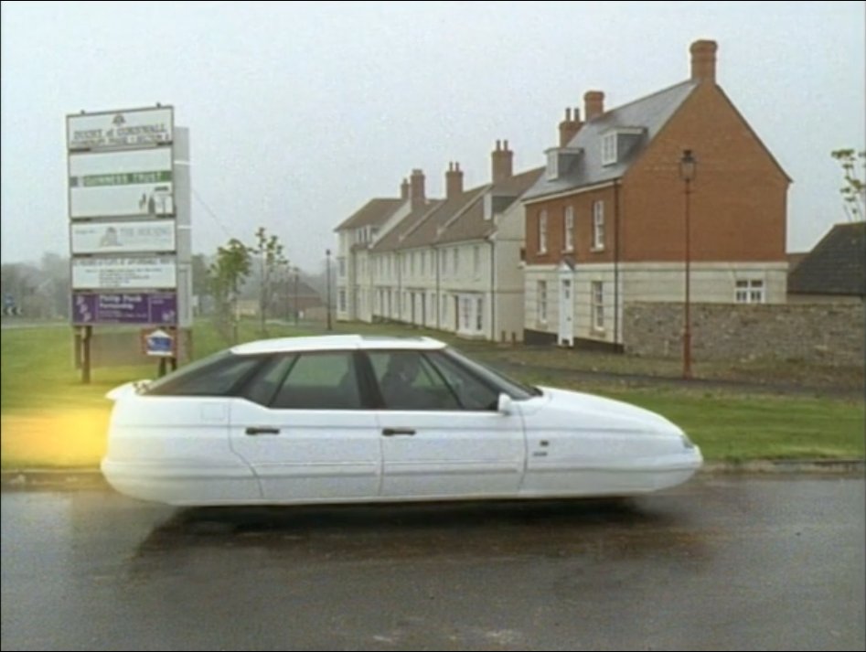 Excoriating Poundbury w/ a fake Delorean 'Compare this might with the retro-puniness which is today’s future. This is today’s future, decreed by the future king... We’re invited to advance, timorously into the past, my only response is to conchie out, to retreat into the future.'