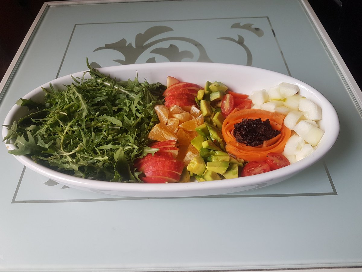 Quarantine cuisineLunchGarden salad with Arugula leaves, apples, tangerines, avocado, cherry tomatoes, carrots, sun dried tomatoes and cucumbers