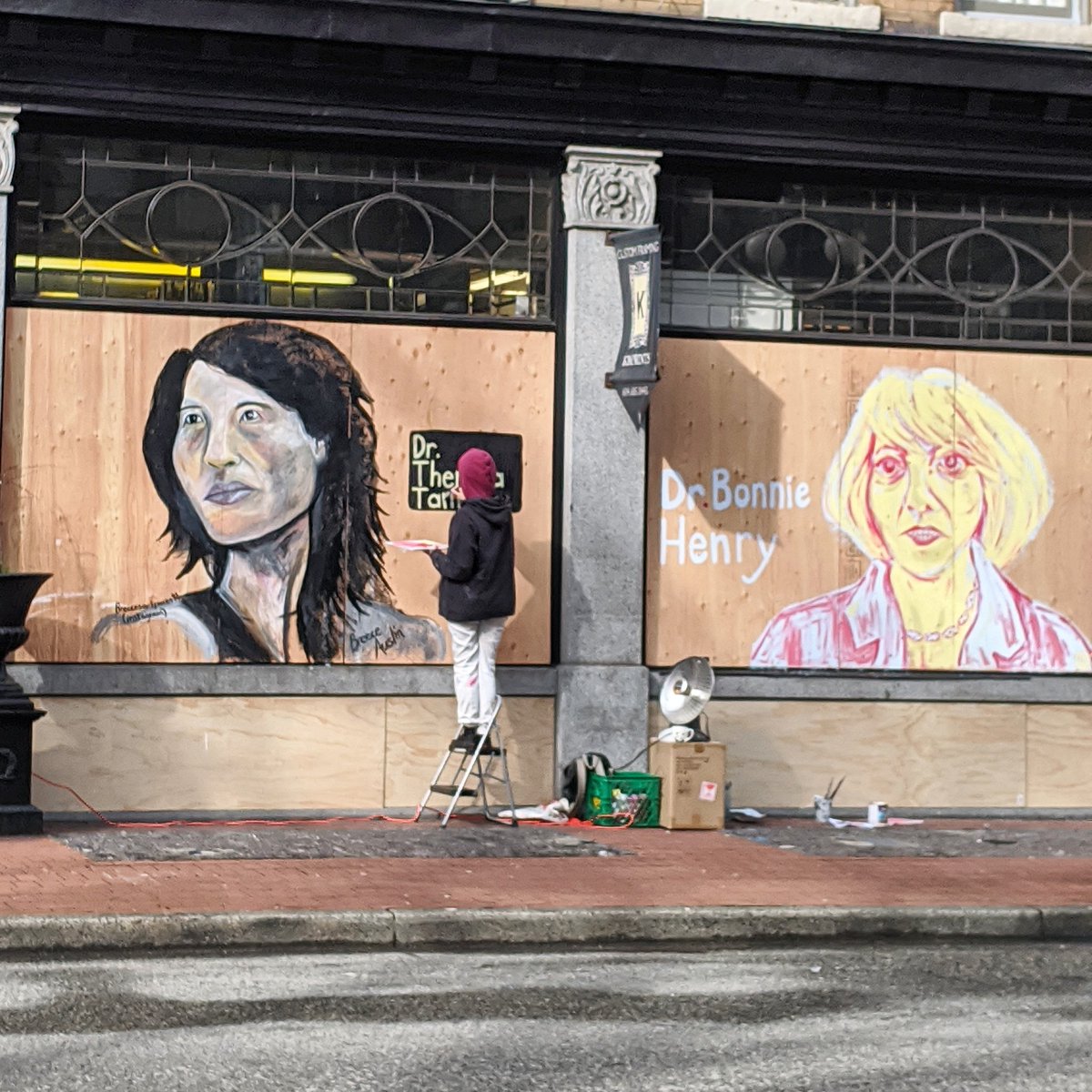 Surreal #covid19bc sight of the day. Larger-than-life murals of <a href="/CPHO_Canada/">Canada's CPHO</a> and Dr. Bonnie Henry being painted, on an empty street in a shut-down neighbourhood in boarded-up Vancouver.