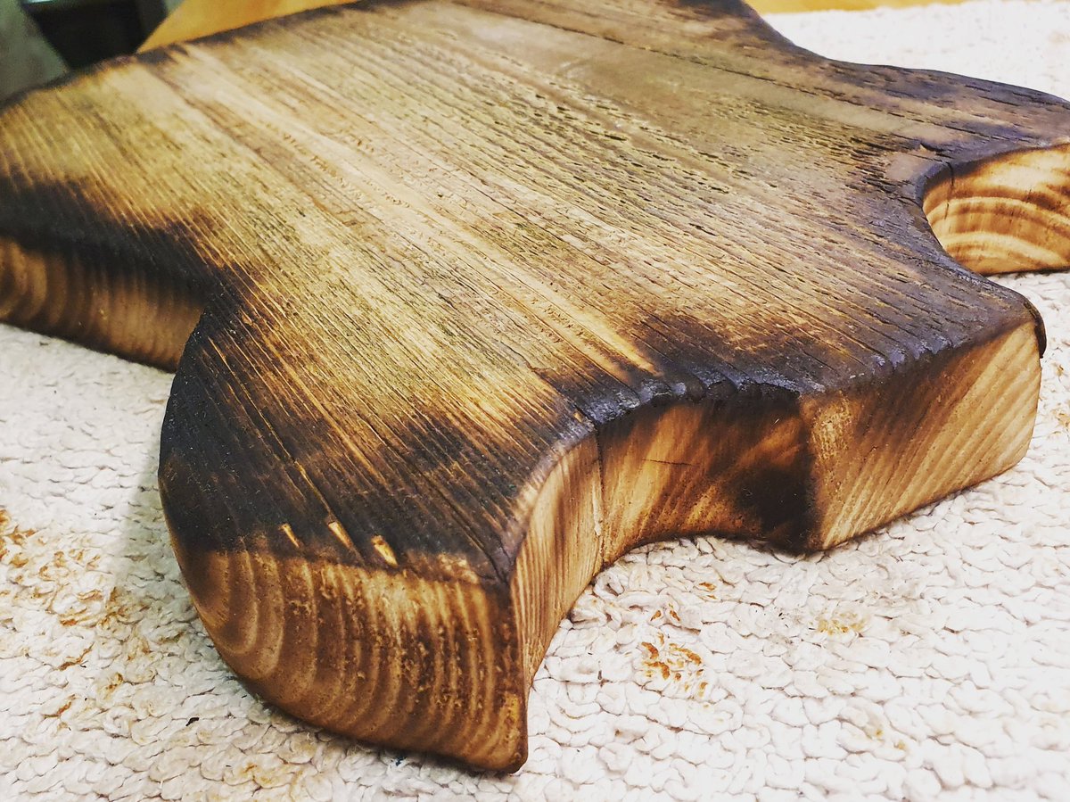 que_vino's tweet image. Current project is 2 bits of old scaffold board glued together, hand sawn and sanded, then burnt round the edges. Next job is neck and pickup cavities. #lockdown #nopowertools