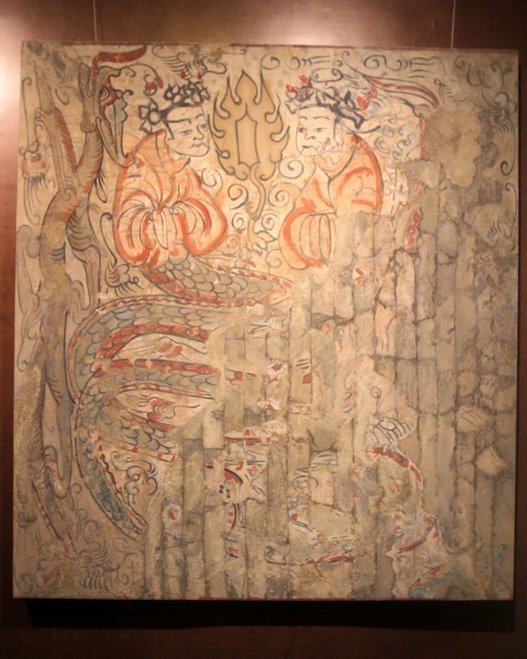 Fu Xi and Nü Wa are typically shown with lower body of snakes, tails intertwined, as we also see them in this later Tang funerary banner from Astana, Xinjiang. 7/9