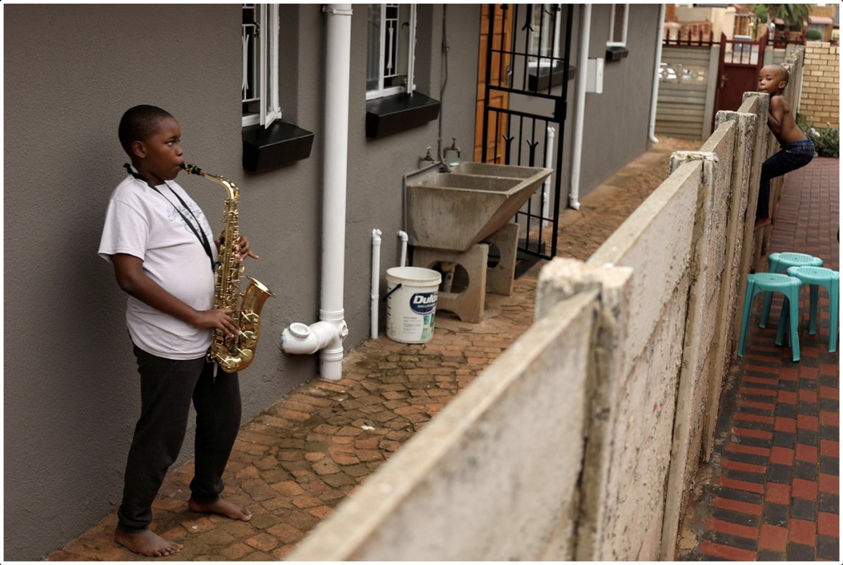 Justice Malala (@justicemalala) on Twitter photo Gorgeous gorgeous picture taken in Soweto by <a href="/SiphiweS/">Siphiwe Sikhosana</a> (Siphiwe Sibeko - Reuters) published in today's @TimesSelect: Ntsika Ntsele (13) plays an alto saxophone while his neighbour looks on. Made me terribly, sadly, happy. #COVID19SouthAfrica #COVID19 #lockDownSouthAfrica Gorgeous gorgeous picture taken in Soweto by <a href="/SiphiweS/">Siphiwe Sikhosana</a> (Siphiwe Sibeko - Reuters) published in today's @TimesSelect: Ntsika Ntsele (13) plays an alto saxophone while his neighbour looks on. Made me terribly, sadly, happy. #COVID19SouthAfrica #COVID19 #lockDownSouthAfrica
