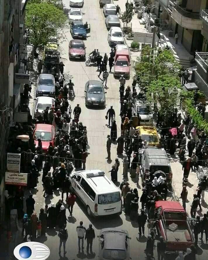 Crowds gather in Jaramana today, on the outskirts of Damascus, to receive humanitarian aid from the Red Crescent.