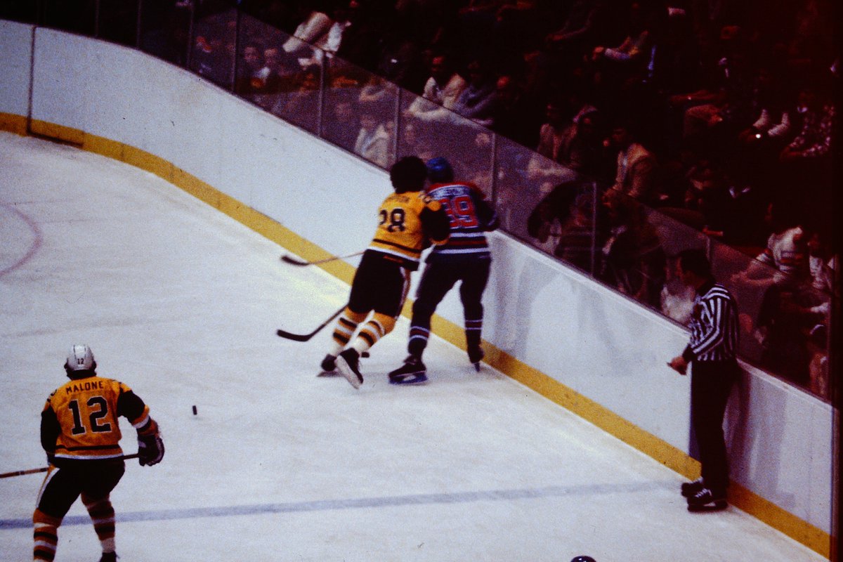 Some throwback Penguin Players...Lets see who can name them. Also take note of the low glass that allows the fans to hang over.