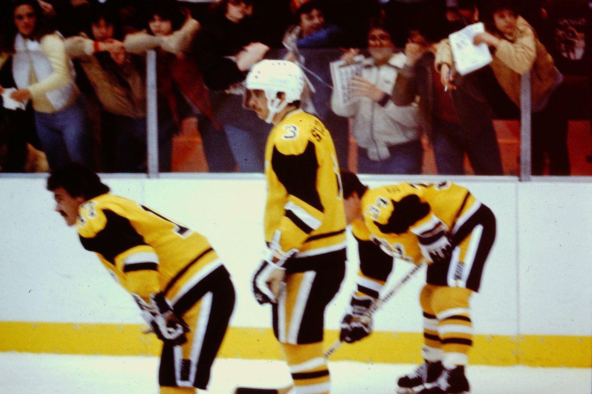 Some throwback Penguin Players...Lets see who can name them. Also take note of the low glass that allows the fans to hang over.