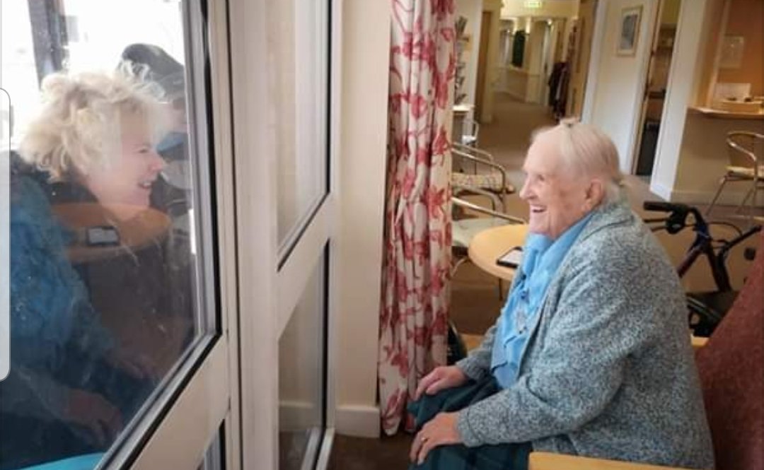Families talking through the window, with 101 year old Joan. We're trying, but it makes me feel very sad ... #StayHome #ClapForCarers