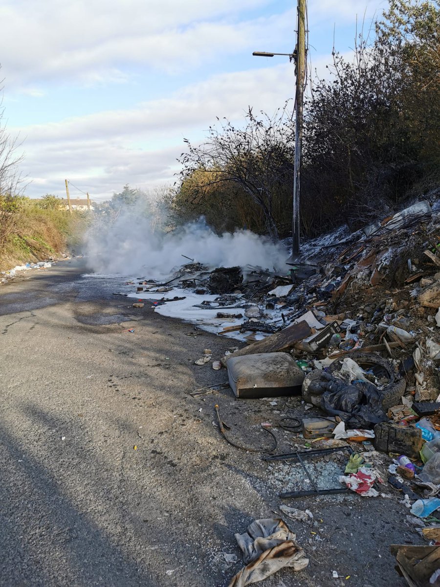 DubFireBrigade's tweet photo. If you take advantage of the offer made on flyers like these, or use unlicensed waste collectors, this is generally what happens. 

Dumped on the side of the road and burned. 

This fire was extinguished last night by Firefighters from Finglas. https://t.co/sDjYrPMnyd