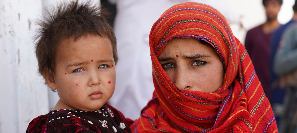 People of Badghis: A 12-year-old girl holds her baby sister outside a nutrition centre in a camp for internally displaced people near the city of Herat. The two girls came here with their family to escape fighting in their home province of Badghis.Picture taken by Mr Husseini.