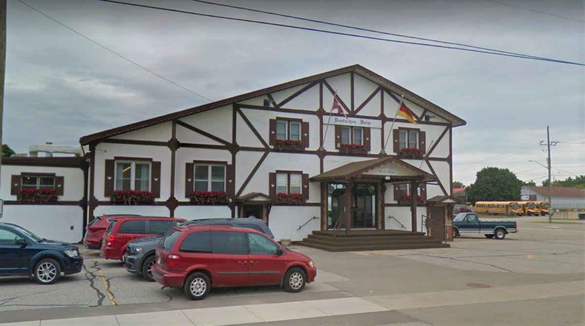 A very early photo of the Delhi District German Home compared to today (with a little help from Google Maps). Note the grassy open space on the right with telephone poles in the distance.