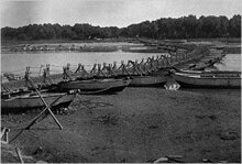 The use of vessels in war first shows itself in the campaigns f Alexander who effected his passage across the Indus, with help of Raja Ambhi of Taxila, and the Hydaspes by a bridge of boats.Image of a pontoon bridge on Ravi river, Punjab , 1945.