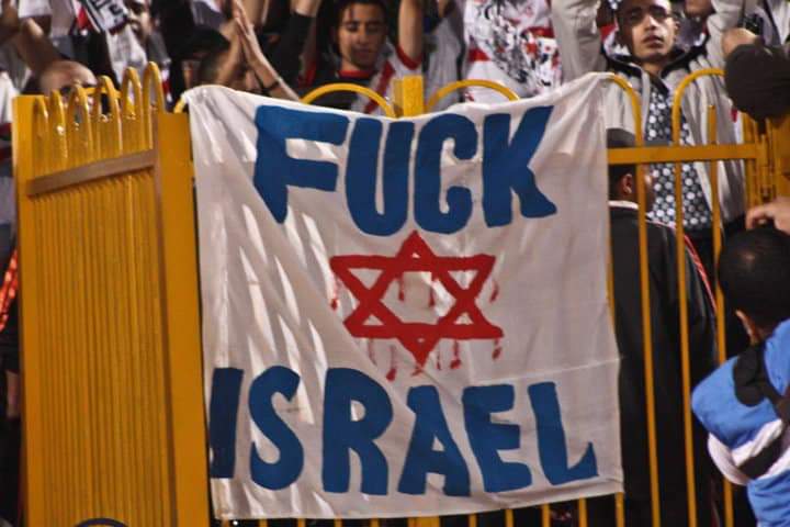 "One nation for new holocaust"
١١ دقيقة مرت من عُمر المباراة وبدأت المحرقة في تالتة يمين إستاد الرعب مع أغاني وأهازيج الفرسان "أكشن".. “ أُمّة واحدة من أجل محرقة جديدة “ للصهاينة