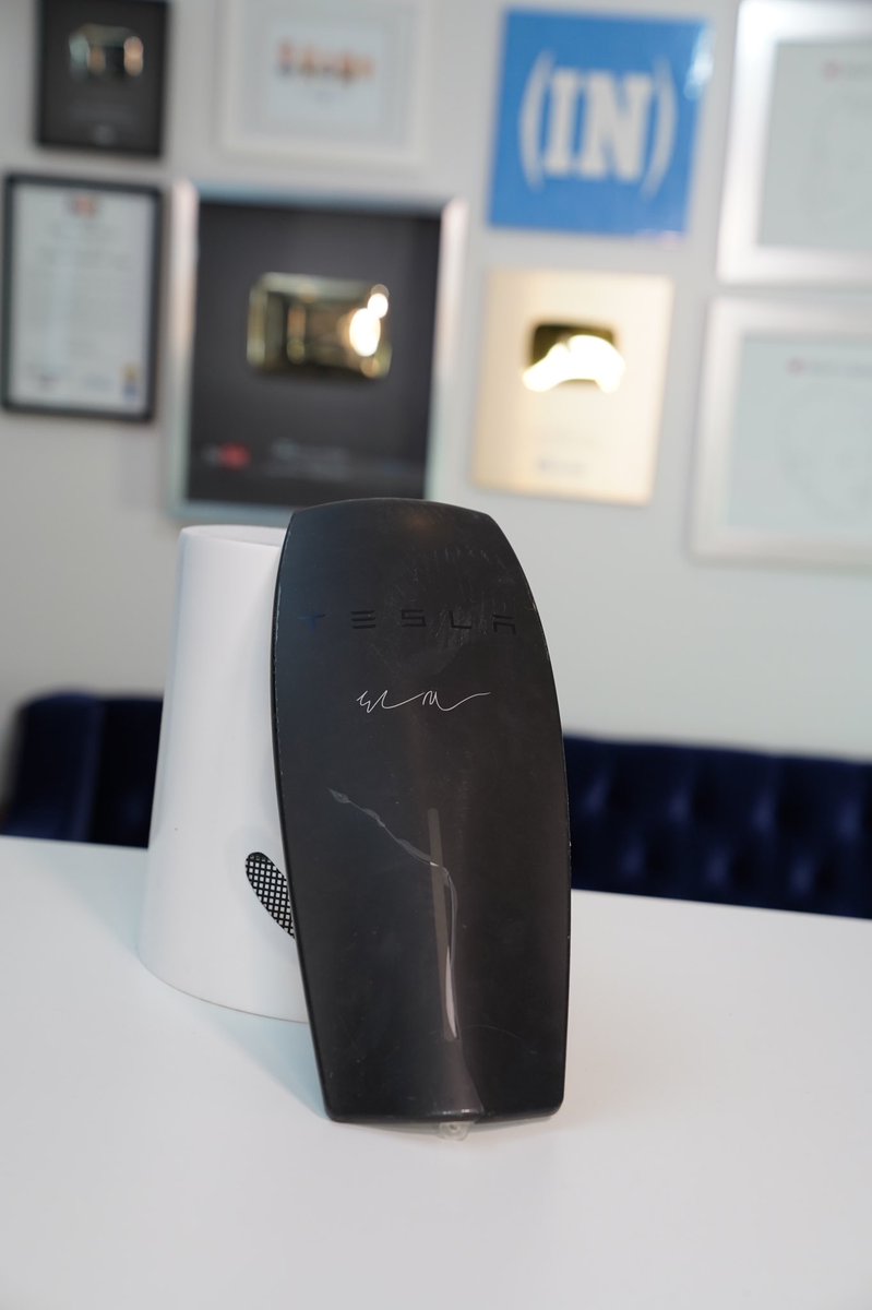 whatsinside's tweet photo. This is the signed by Elon cracked home wall charger cover from our video. If someone wants this, rt this and follow us and I’ll pick someone tomorrow. https://t.co/3mzjeFpK74