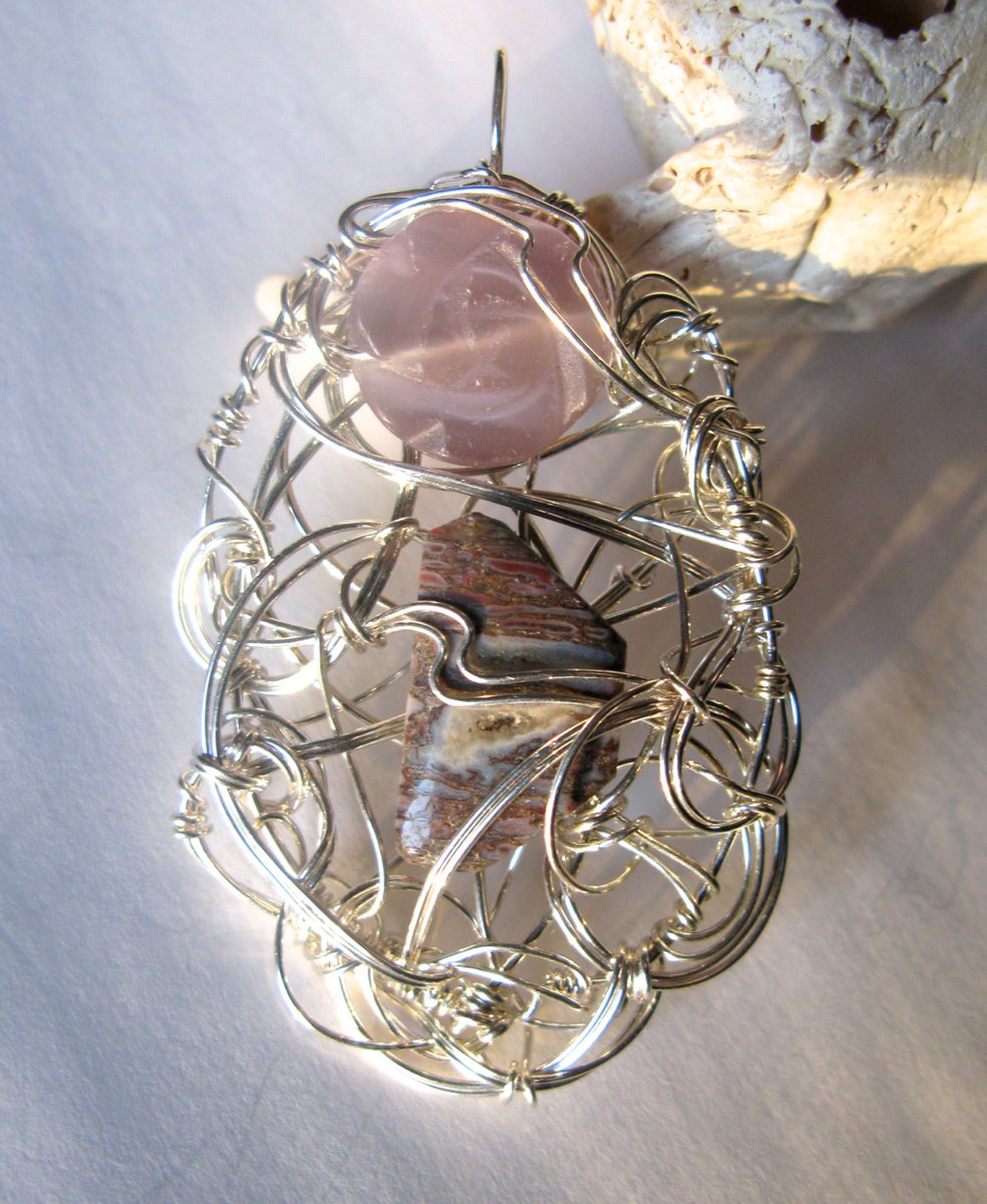 "Postcards from the Older World" is another dinosaur bone pendant, this time with a carved lavender glass rose. (It's that fiber-optic glass, so there's a bit of chatoyancy going on there too.)