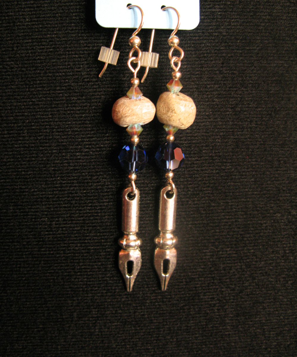 There were some stegodon bone bead pieces as well. "In Search of Older Words" is a pair of earrings with stegodon bone, Swarovski crystal, and pen nib charms.