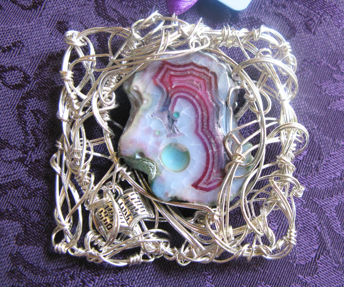 There is a pendant called "Two Journals and the Stars," which is also a writing pendant. It uses dyed agate which I think someone was trying to make look like watermelon tourmaline but they got half the batch color-reversed. This piece isn't, but it's not tourmaline-y.
