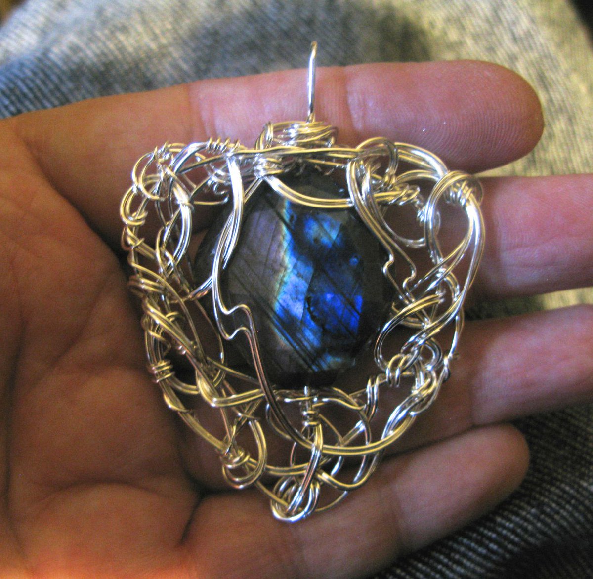 From silly to serious, now. This is "Decrypting the Nebula," a labradorite pendant with some rather interesting faceted labradorite.