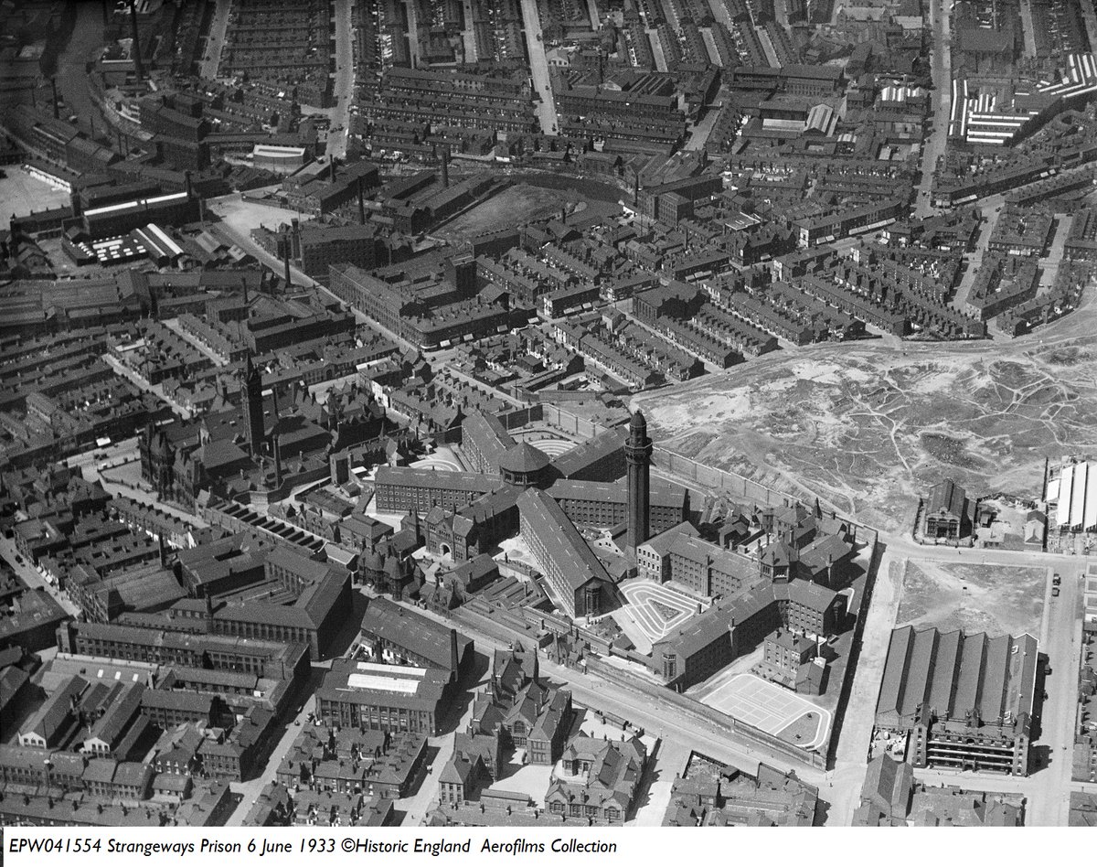 1 Taken in 1933 this aerial photograph shows Strangeways Prison. The large building with a tower towards the left is the Assize Court. Designed by Alfred Waterhouse in the neo-Gothic style and completed in 1864 the building was demolished in the mid 1950s due to WWII bomb damage.