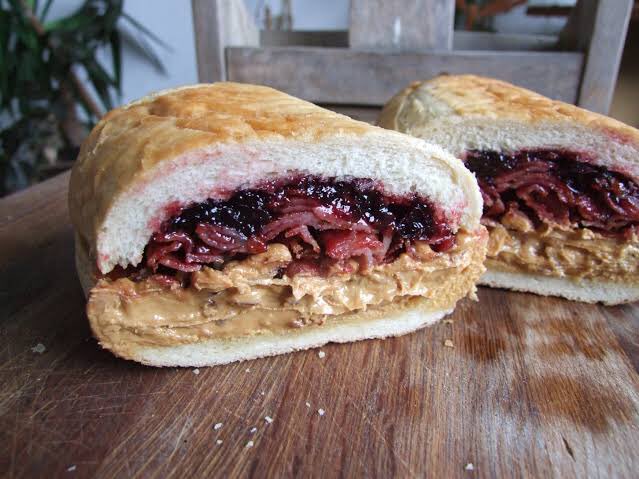 Every year I talk to you about Elvis’ favorite sandwich. This is VITAL information and therefore has become a tradition. The sandwich is made of a loaf of bread filled with the contents of a jar of peanut butter, a pound of bacon and a jar of jelly. Elvis used to fly from +
