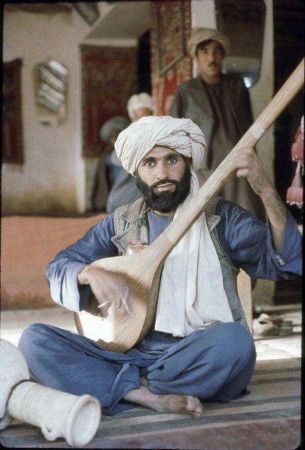 A musician in Balkh city with his musical instrument while wearing a plain turban.This picture must be 50 years old.