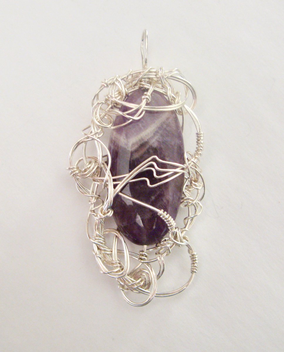 Another amethyst in the pendant called "When Starships Dream." The V marking of lighter purples and white is a classic look of dogtooth amethyst.Note that use-names in the bead trade don't always match real geology names.We will pause here for geologists to finish laughing.