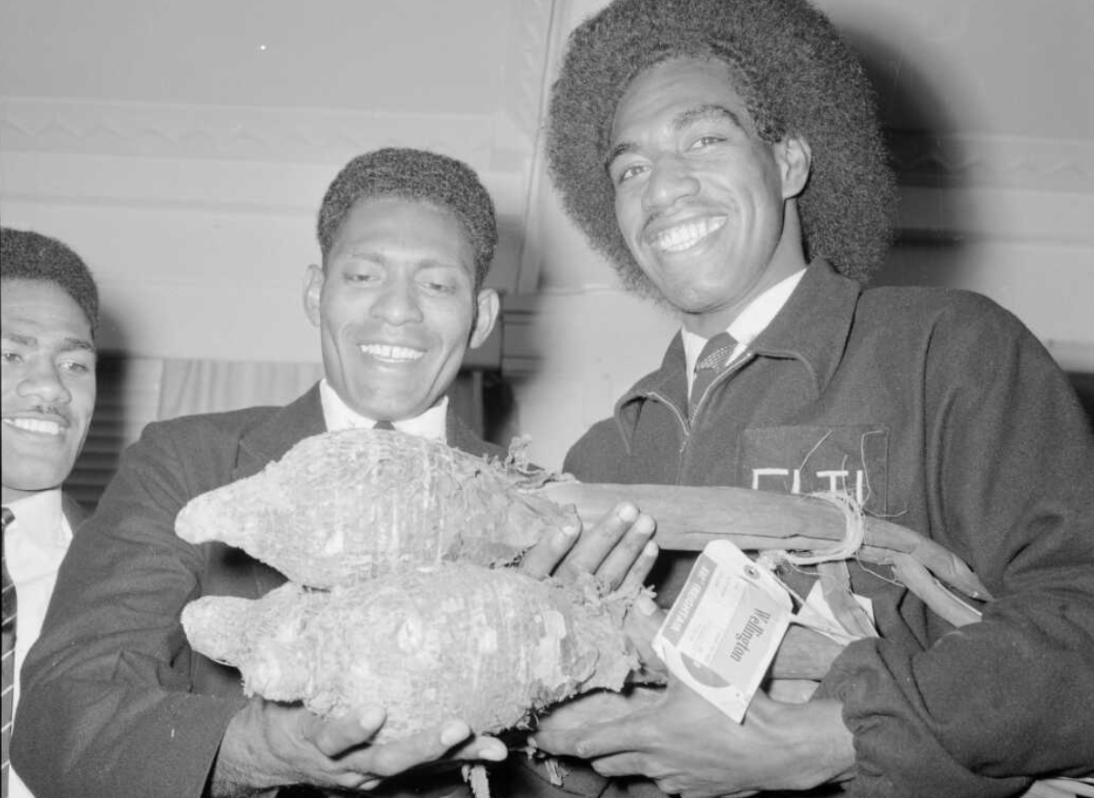 Feeling depressed? Behold happiness. Photo by an unnamed Evening Post photographer in New Zealand in 1957. Fijian rugby players overjoyed at having being sent taro from home.