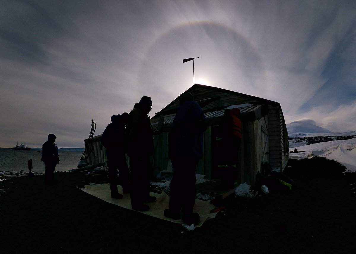 DanBrownNature's tweet photo. A superb #sunhalo over #mounterebus #Antarctica as we visited Scott’s Hut at #Capeevans. This place is spectacular on any visit let alone with this meteorological bonus. Also second halo behind #Rosssea legend David Harrowfields head off #snaresislands #stormhour #weatherwatching https://t.co/DojvwVAzyO