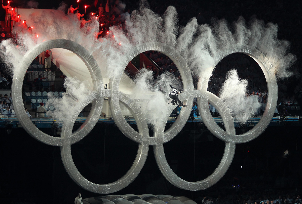 SteveRussell's tweet photo. Over the sports void created by the COVID-19 pandemic I have been sharing sports photos from my 25 years at @TorontoStar. A snowboarder flies through the Olympic rings during the Opening Ceremonies for the Vancouver 2010 Winter Olympiad. https://t.co/R0q1mXgUOW